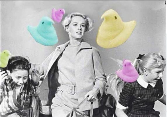 A black and white photo from the movie, The Birds. Instead of real birds flying around, they are replaced with colorful marshmallow Peeps.
