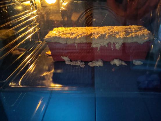 Sourdough bread in the ofen, overflowing the pan