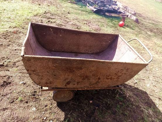 The two pieces, now joined together, the metal tub slotting to the top of the wheeled cart with two fixings on the bottom and kept from sliding sideways by the angled edge.