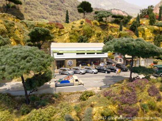 A photo of a VW car dealership on a model railway.