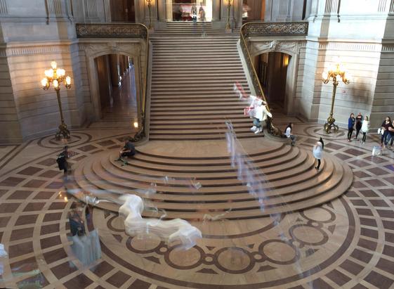 Long exposure of people on a long stairway/ornate entry way.