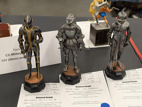 Three suits of plate armour