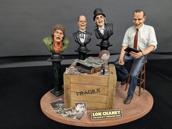Lon Cheney with his makeup kit, and busts of his characters in The Hunchback of Notre Dame, The Phantom of the Opera, and London by Midnight