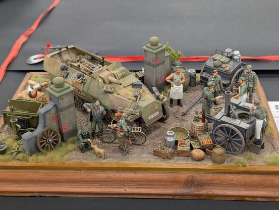 Diorama of German soldiers with a field kitchen and a half-track.