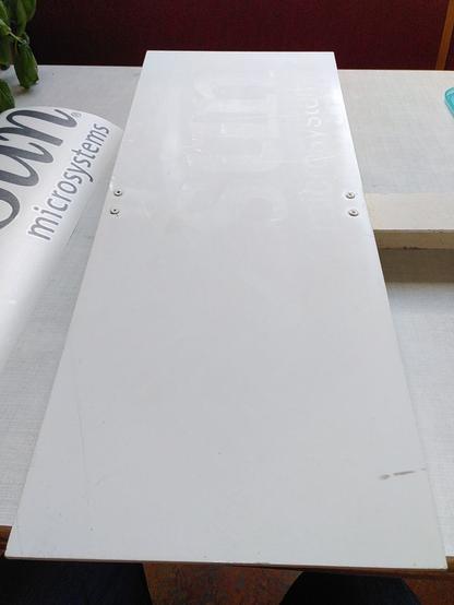 Faded old sign. Text is only readable by observing surface finish