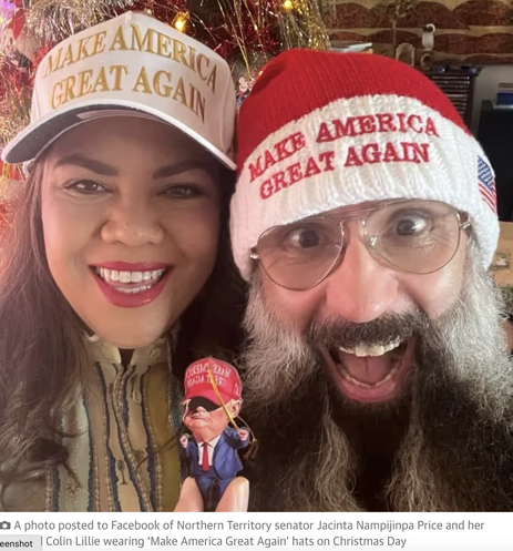 Jacinta Price and husband wearing MAGA hats with a Trump doll.
