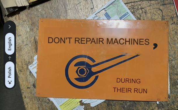 A Polish sign that has been translated into English saying Don’t Repair Machine During Running.