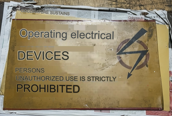 A Polish sign that has been translated into English saying Operating Electrical Devices by Unauthorized People Prohibited.