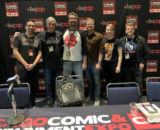 HWA Chicagoland chapter members Aleco Julius, Brian Pinkerton, David Rider, Scott Kenemore, Gwen Woods, and Christopher Hawkins stand together before a C2E2 backdrop; photo credit: Brian Pinkerton