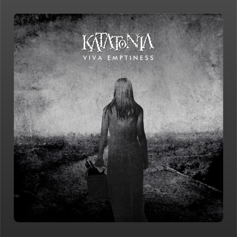 The album cover of Viva Emptiness by Katatonia features a haunting, monochromatic image. A solitary female figure, seen from behind, stands in a desolate landscape under a bleak sky. She wears a long, dark dress and holds a basket in her right hand, the contents of which are indistinct but add to the eerie atmosphere. The overall texture is rough and grainy, giving the artwork a distressed and somber tone. Above the figure, the band's name “Katatonia” is displayed in a jagged, weathered font, with the album title “Viva Emptiness” written clearly beneath it in capital letters. The imagery conveys themes of isolation, melancholy, and introspection—fitting for the band’s melancholic metal sound.