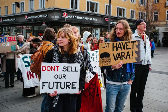 Protesters getting ready to march. A placard says "Don't sell our future".