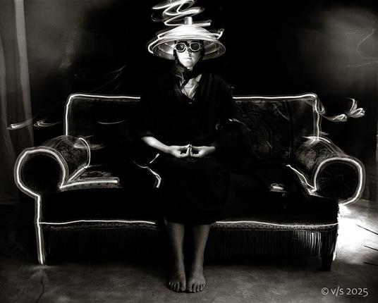 B. sitting on a sofa