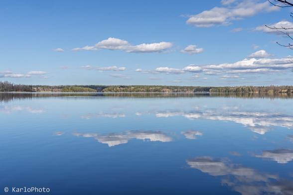 A lake with clouds mirrored from the sky above.