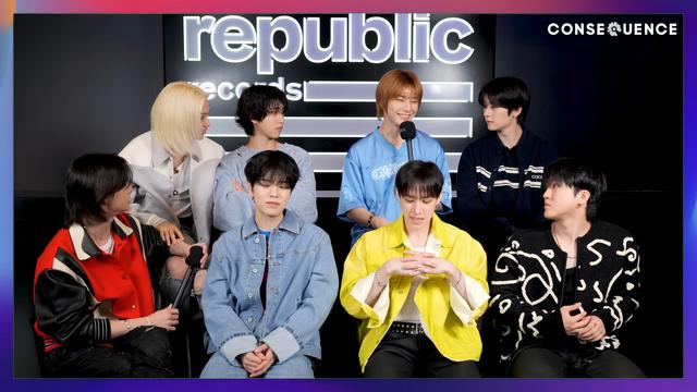 Skz members during an interview. I.N is about to speak and he's very pleased with himself.