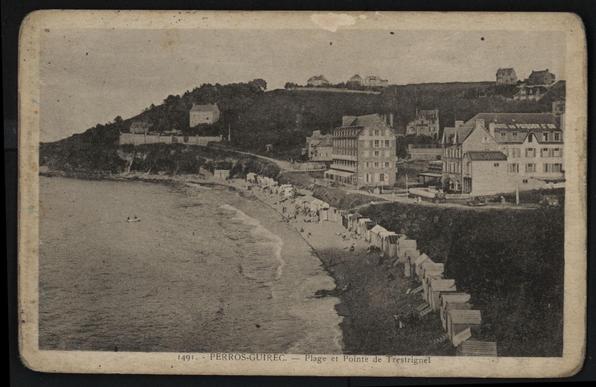 A vintage black-and-white postcard depicting the beach at Perros-Guirec, France. The scene features a shoreline with several beach huts, people relaxing, and a few boats in the water. In the background, there are buildings and hills