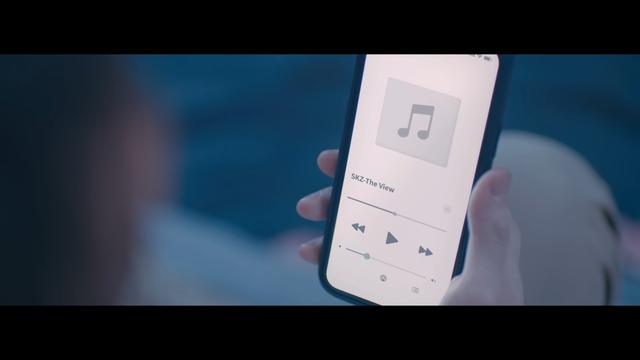 Bang Chan holds his phone sadly while he plays skz's song "The View"