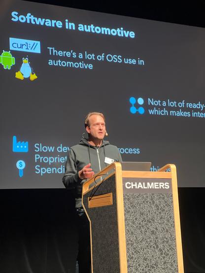 Tomas on stage in front of his slides.