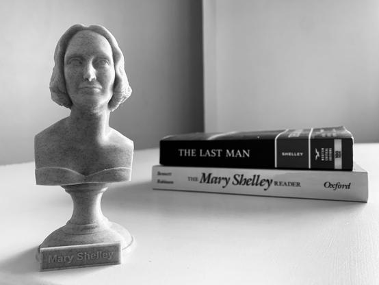 Pictured (in black and white) is a bust of Mary Shelley with her novel The Last Man and The Mary Shelley Reader anthology from Oxford stacked together in the background.