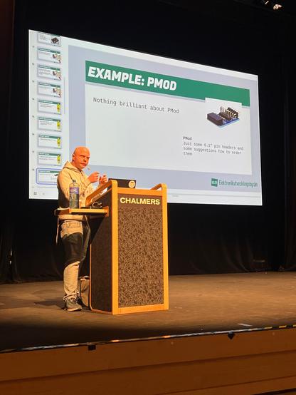 A person standing at a lectern speaking about open source.