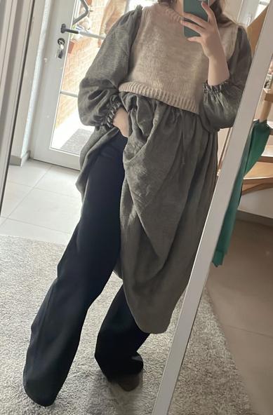 the photo is showing the same linen dress worn over a black washed jeans and with a light color woollen slipover