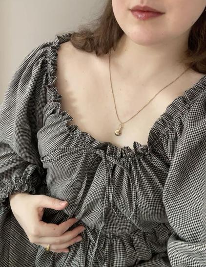 another portrait style photo showing of the gathering of the dress by strings