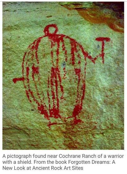 Red paint humanoid pictograph:
A pictograph found near Cochrane Ranch of a warrior with a shield. From the book Forgotten Dreams: A New Look at Ancient Rock Art Sites