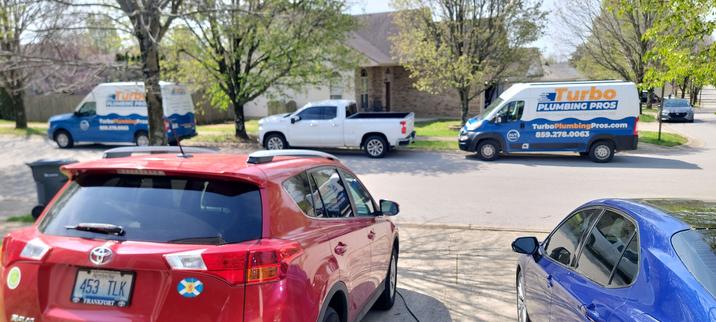 2 plumbing trucks parked on our street.