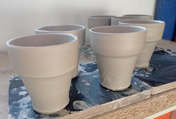 Fitting cups just after throwing. White stoneware ceramics. Pictures show that the seven cups are very similar in dimensions which should permit good fit