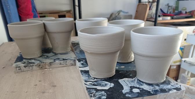 Fitting cups just after throwing. White stoneware ceramics. Pictures show that the seven cups are very similar in dimensions which should permit good fit