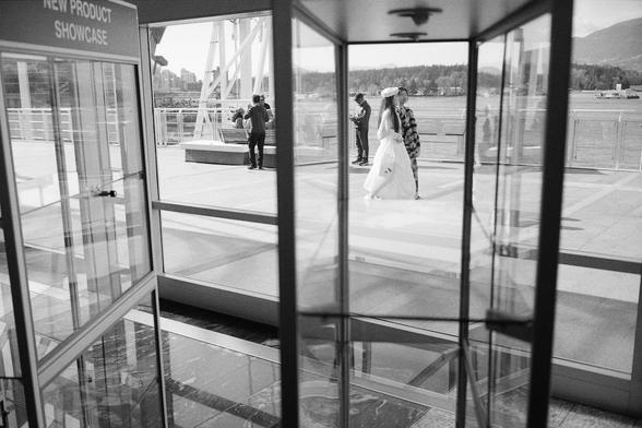 Tourists take the pier in as viewed through glass facets.