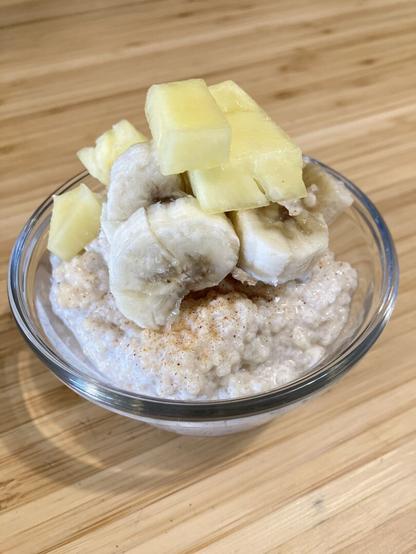 A pudding made of couscous topped with banana and pineapple.