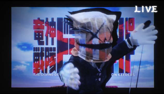 A screenshot from Go Go Loser Ranger season 2 showing a puppet being visibly puppeteered combined with animated portions for a unique visual effect.