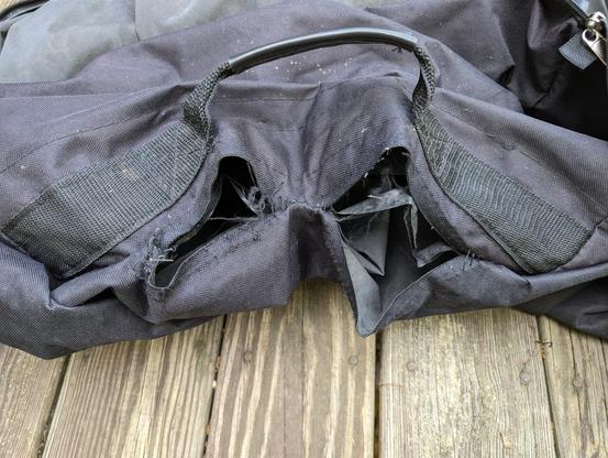 inside of the blown seam showing the gaps between the canvas sides and the detached seam tape