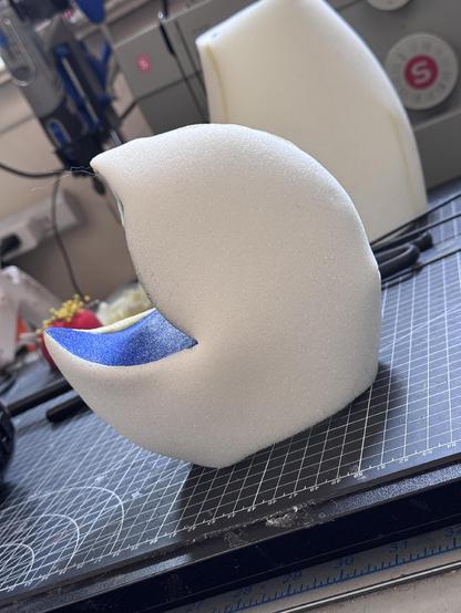 A foam puppet head with an S curve mouth plate open mouth