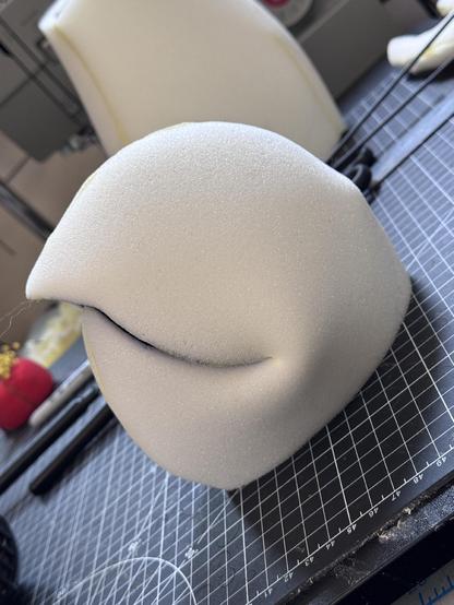 A foam puppet head with an S curve mouth plate closed mouth