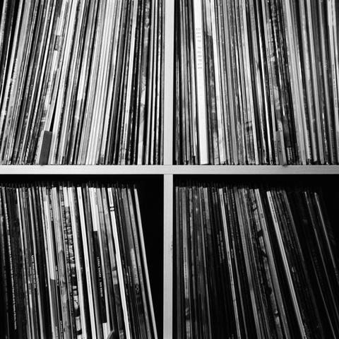 A photo of a bunch of records on a shelf