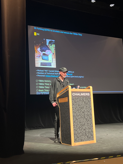 MC standing at a lectern talking about the TKey