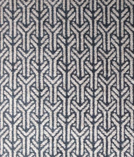 A black and grey carpet with interlocking Y-shaped motifs.