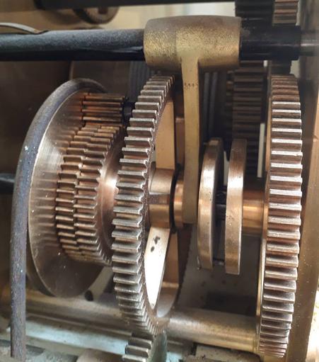 A closeup of a series of gears on a common axle