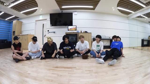 Skz members sit on the floor of a dance practice room. Changbin's sitting on Seungmin's lap, leaning back with his head on Seungmin's shoulders.