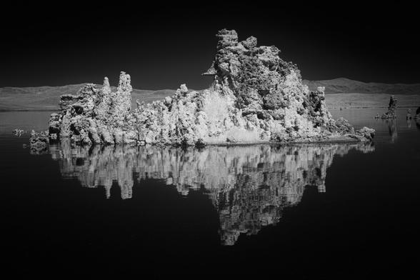 I captured this frame with my 830nm “deep infrared” filter on a full-spectrum camera during a mid-day stop at Mono Lake, California. This wavelength is well beyond the visible spectrum, creating dramatic black-and-white images with dark skies and bright highlights. It always makes me think of Ansel Adams. Some say he loved infrared film, others say he preferred traditional black-and-white with a red filter for contrast. Either way, I think of him when shooting nature sans color. The tufa tower shown here is made of limestone formed when carbonate-rich springs—often called “soda springs”—flow into alkaline lakes and precipitate minerals. Mono Lake is famous for these unique and sometimes towering formations.