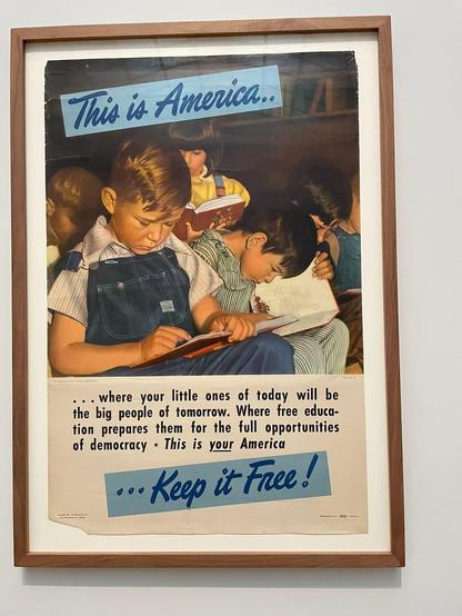 A photo of an old 50s/60s American poster showing children learning, with the slogan " This is America... where your little ones of today will be the big people of tomorrow. Where free education prepares them for the full opportunities of democracy. This is your America, keep it free!"
