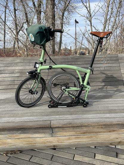 My Matcha green Brompton bicycle posing on a city bench. Her name is Mon Petit Chou or My Little Cabbage.