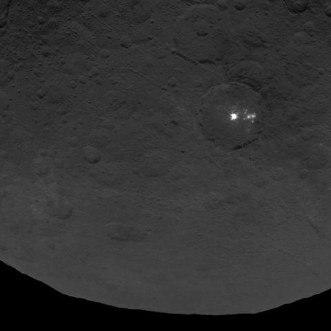 A cluster of mysterious bright spots on dwarf planet Ceres can be seen in this image, taken by NASA's Dawn spacecraft from an altitude of 2,700 miles (4,400 kilometers). The image, with a resolution of 1,400 feet (410 meters) per pixel, was taken on June 9, 2015. Credit: NASA/JPL-Caltech/UCLA/MPS/DLR/IDA