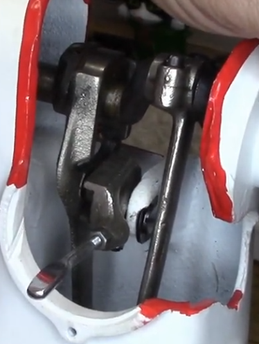 Screen capture from video showing the cam which changes stitch length and the control arm. If this does not move, the stitch length will not change.