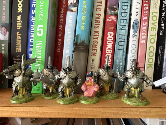 some big kitbashed silver knights the colours of swedes and mr blobby weilding a pin