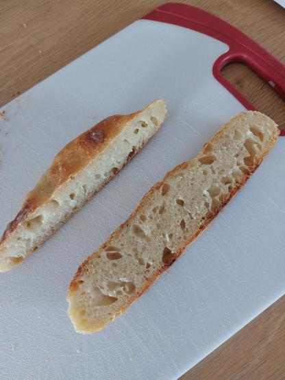 slices of a flat overproofed sourdough loaf.  It has some nice looking bubbles and crumb though