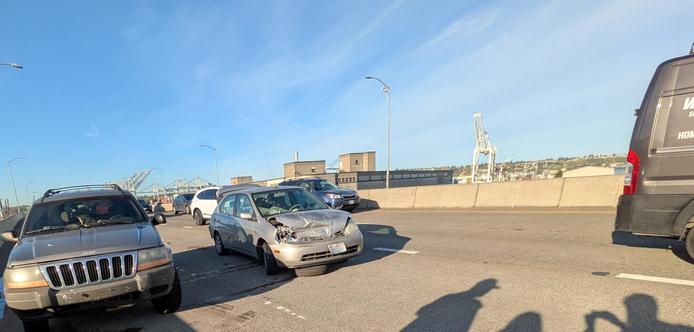 Car crash on SR99, an ancient prius is crumpled from an accident in the middle of traffic