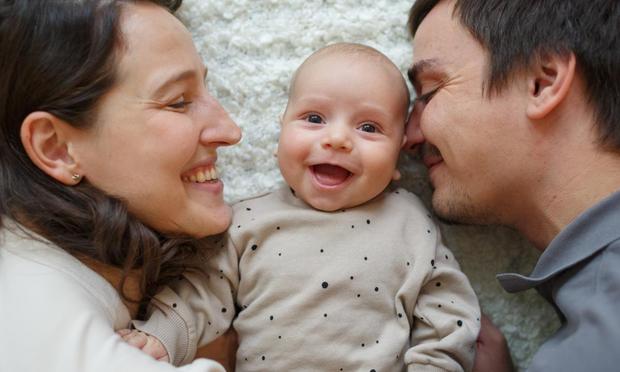 Madre, bebé y padre sonrientes. (Getty Images)