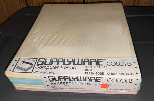 Multicolor pack of 9.5" perforated computer paper. The SUPPLYWARE logo uses a retro computer font; the pack is separated in 5 100 pages of different colors.